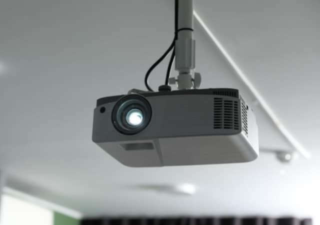 Image of a ceiling mounted projector in a room