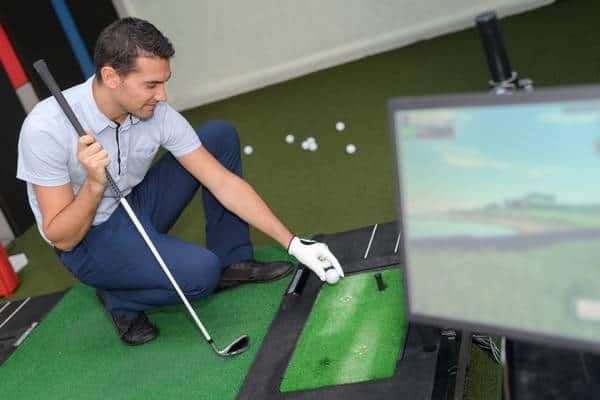 Young man playing virtual golf