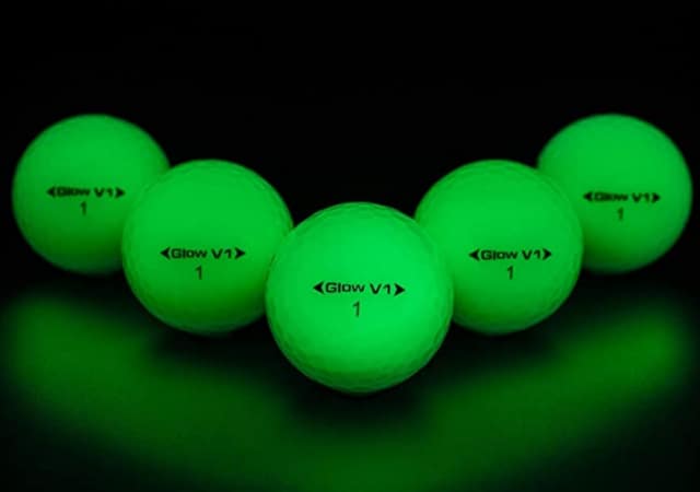 Five GlowV1 Night Golf Balls in a dark room