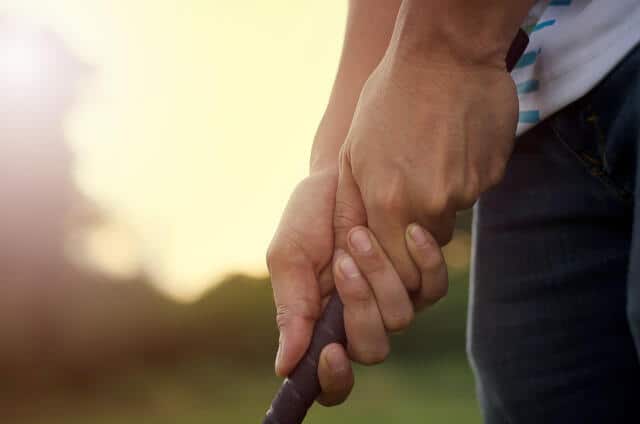 Demonstration of a Conventional Grip by a golfer on a golf course