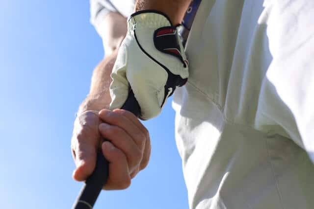 Demonstration of a 10 Finger Golf Grip by a golfer on a golf course