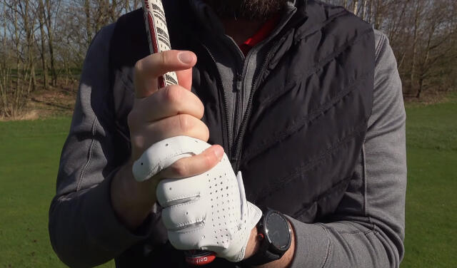 Demonstration of an Interlocking Golf Grip by a golfer on the golf course