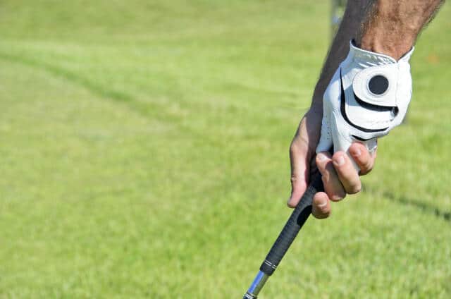 Demonstration of a Vardon Overlap Golf Grip by a golfer on the golf course