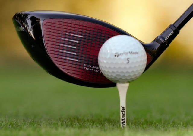 TaylorMade's Stealth Driver, golf ball, and tee on a golf course