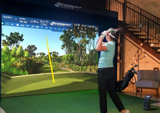 Foresight Sports Sim-in-a-Box Birdie Plus Package Set up with a female golfer using it