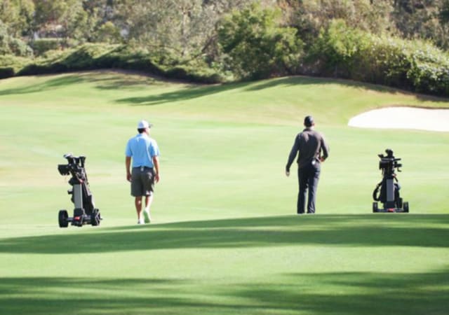 Two Foresight Sports ForeCaddy Smart Cart being used by two golfers on the golf course