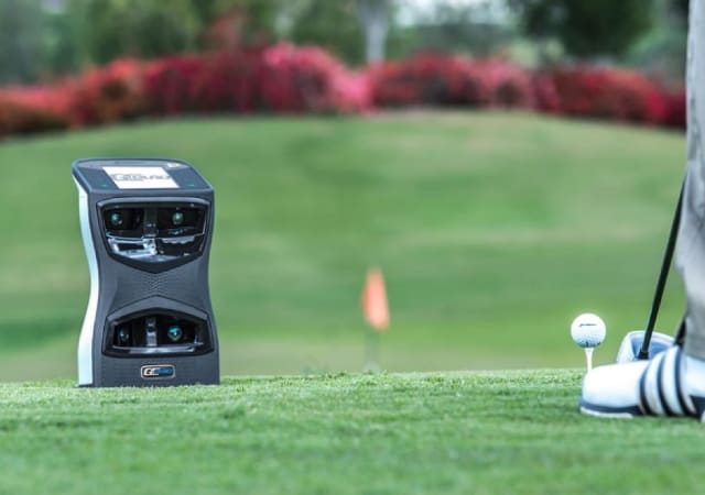 Foresight Sports GCQuad launch monitor on the golf course foot of a golfer preparing for a shot can be seen on the right side of the image