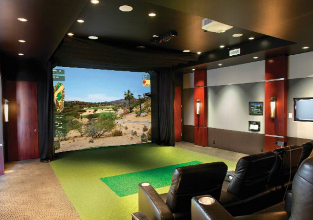 Complete golf simulator indoor setup with couches in the surroundings