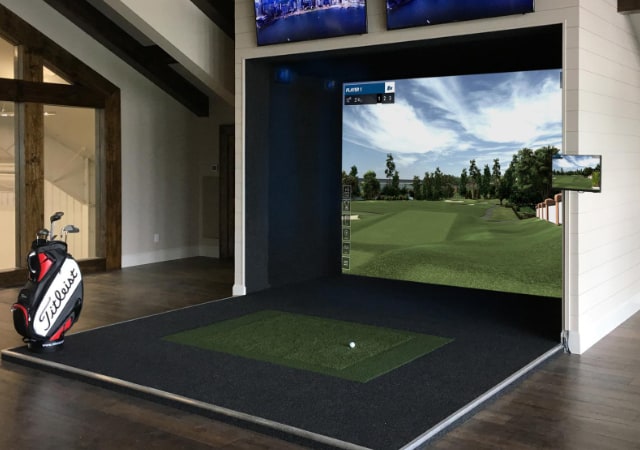 Sports Series simulator complete indoor setup with a golf bag in the surroundings