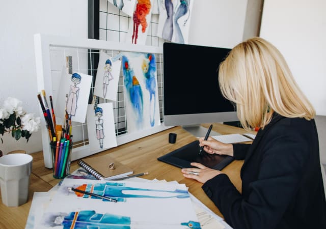 A graphic designer working on her desk