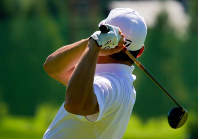 Image of a golfer from the back after completing a golf swing