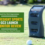 Foresight gc3 launch monitor and a golf ball on the golf course. Green textbox on the left contains the text "Read Our First Impressions. Fresight GC3 Launch Monitor Review. Everything You Need to Know"