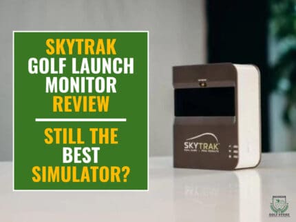 SkyTrak launch monitor on top of a counter. Green textbox on the left contains the text "SkyTrak Golf Launch Monitor Review. Still the Best Simulator?"