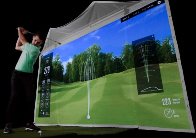 A Golfer using a golf simulation